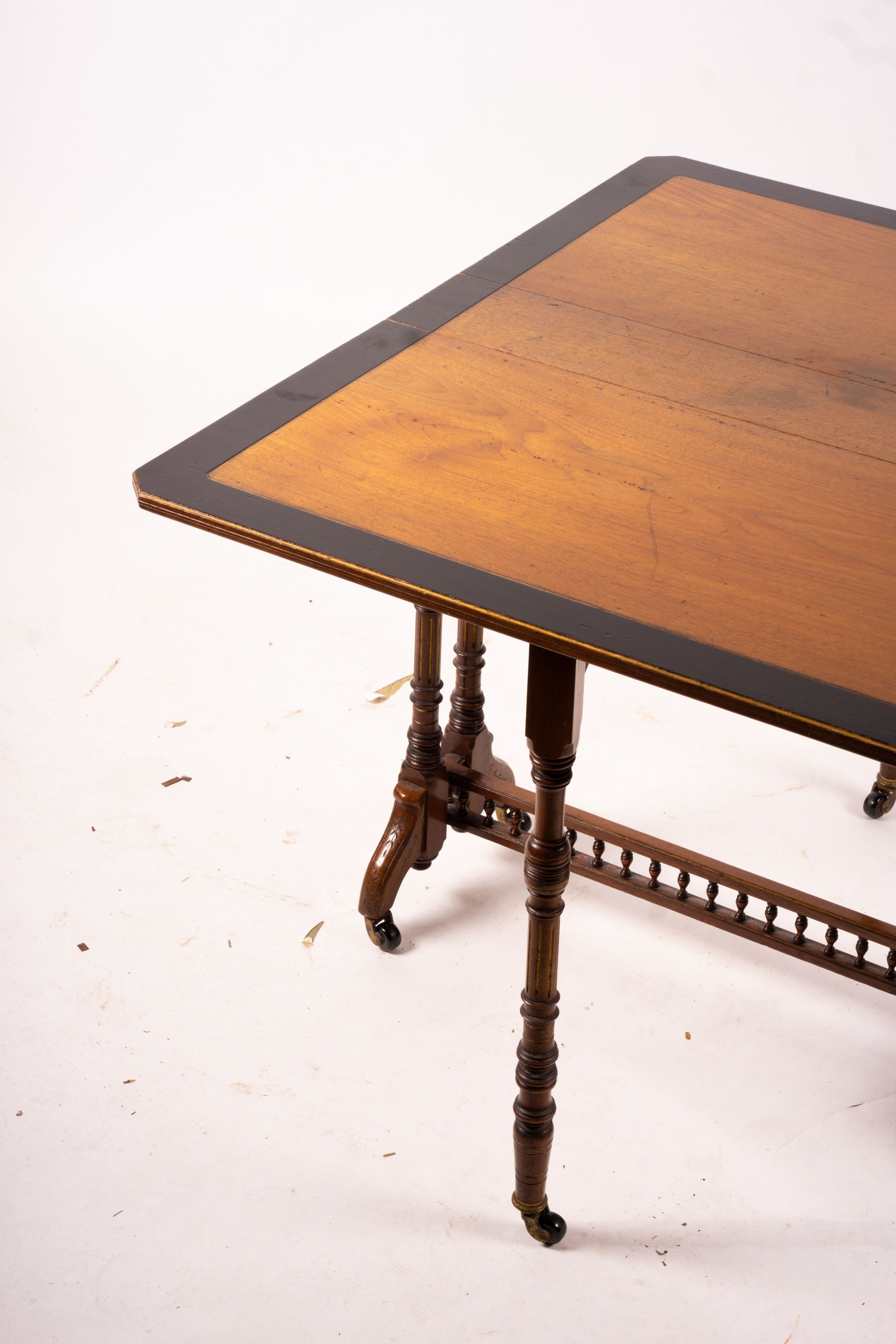 A late Victorian part ebonised walnut Sutherland table, width 76cm, depth 15cm, height 65cm